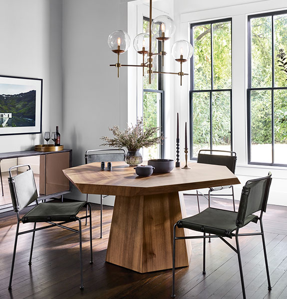 A dining set sits in a well-lit room with simple wire-frame chairs.